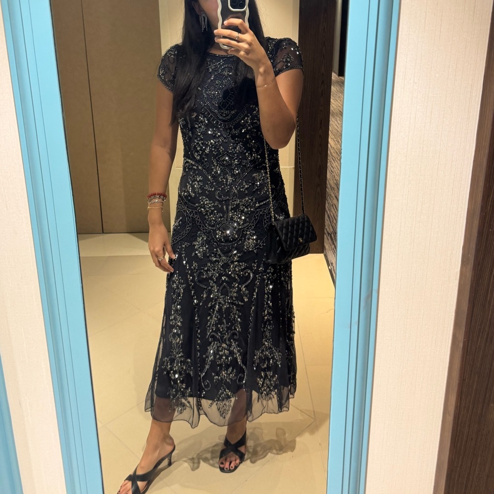 Black sequined dress perfect for wedding guest